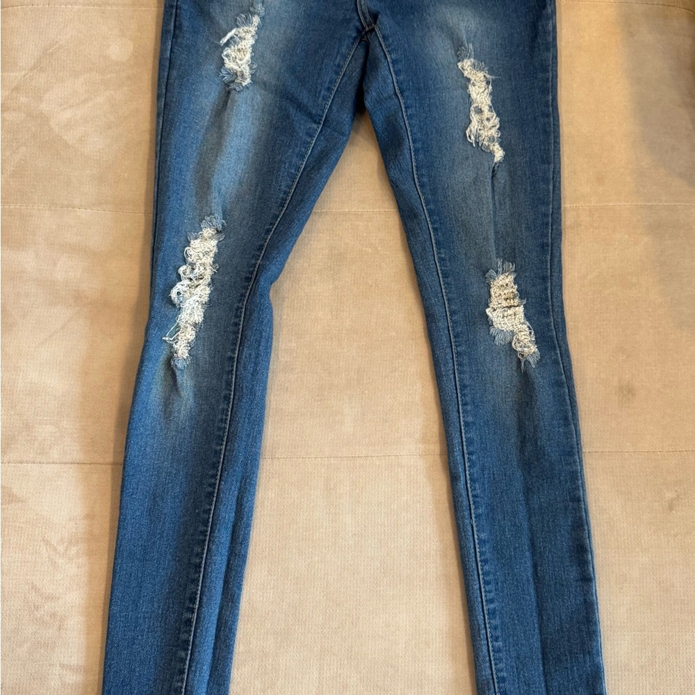 Women’s distressed blue jeans